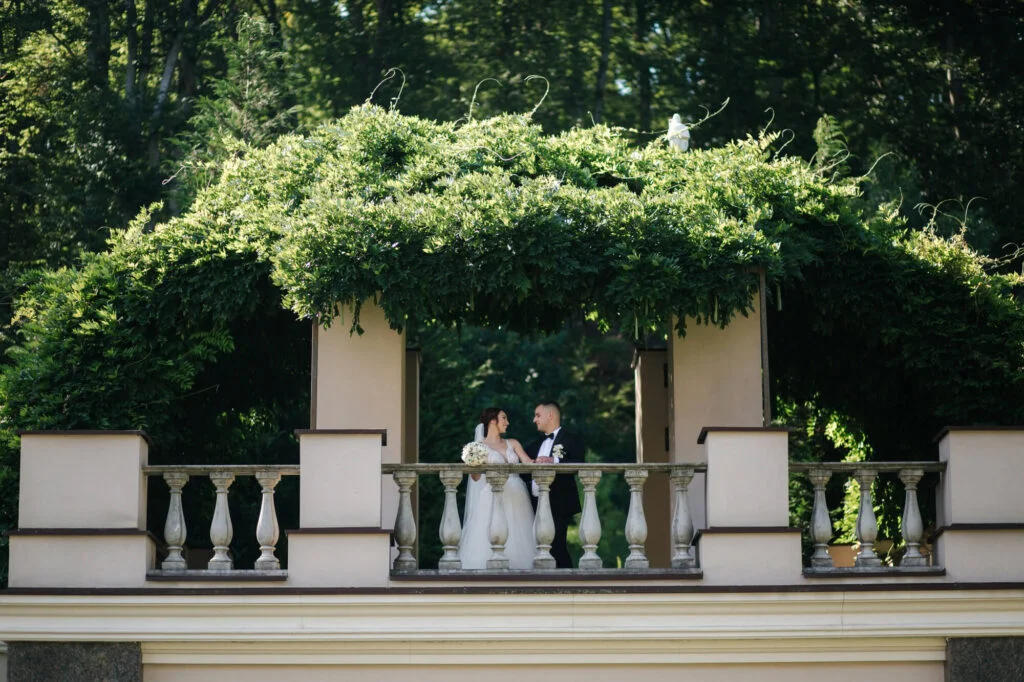 Newly-wed couple taking photo-shoot in our classical-style venue balcony with lush green foliage